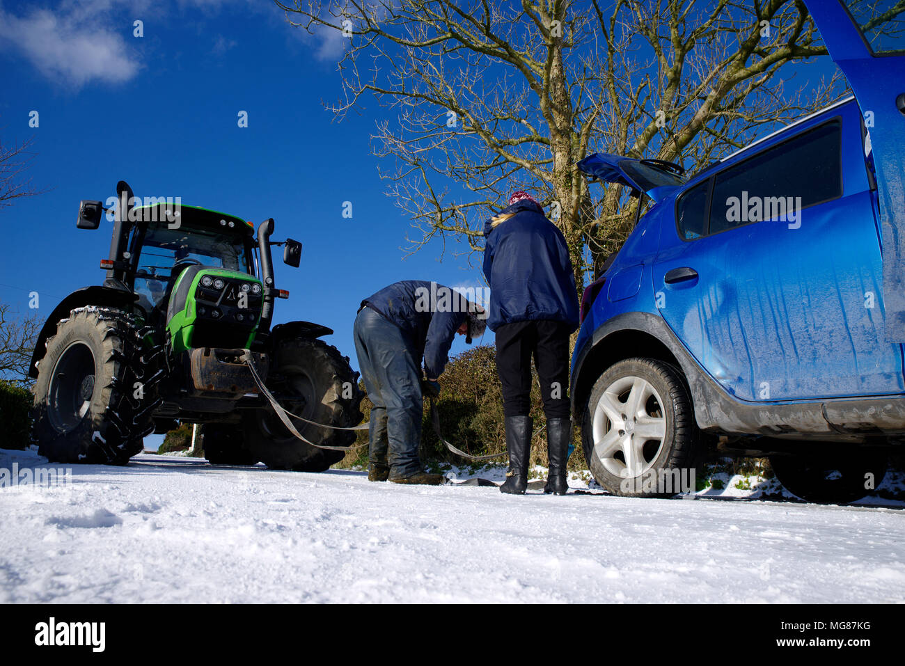 Vehicle on icy road Towed by tractor. Stock Photo