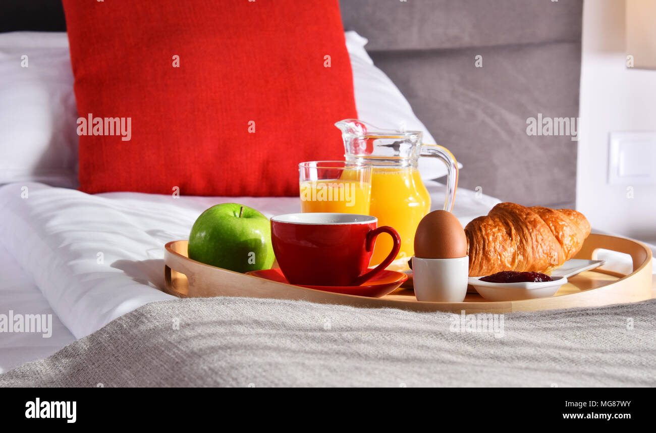 Breakfast on tray in bed in hotel room Stock Photo - Alamy