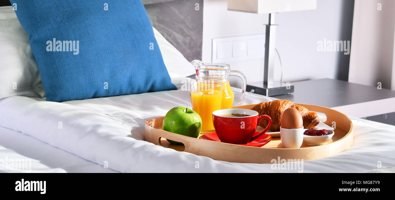 Breakfast on tray in bed in hotel room Stock Photo - Alamy