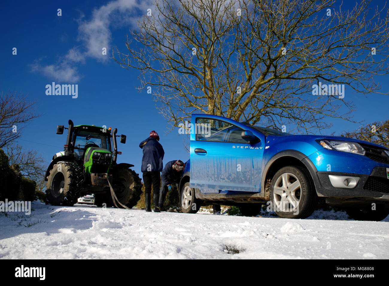 Vehicle on icy road Towed by tractor. Stock Photo