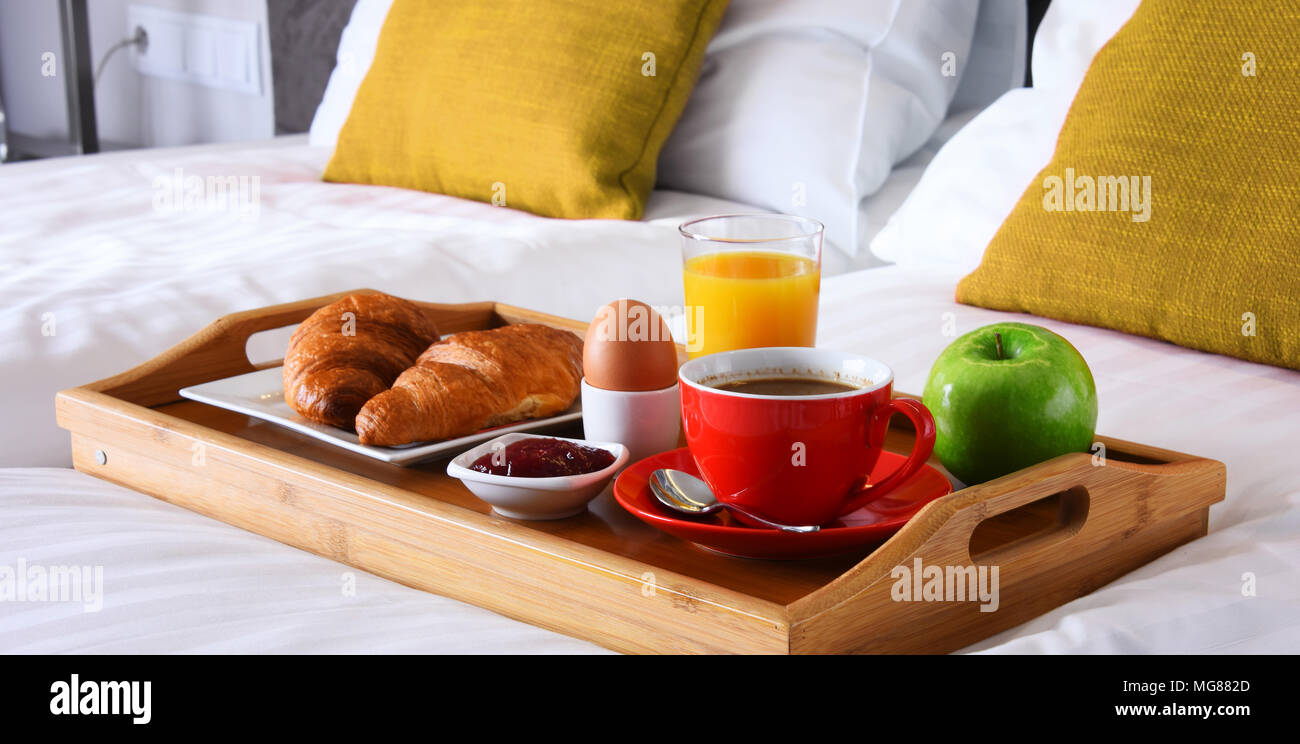 Breakfast on tray in bed in hotel room Stock Photo - Alamy