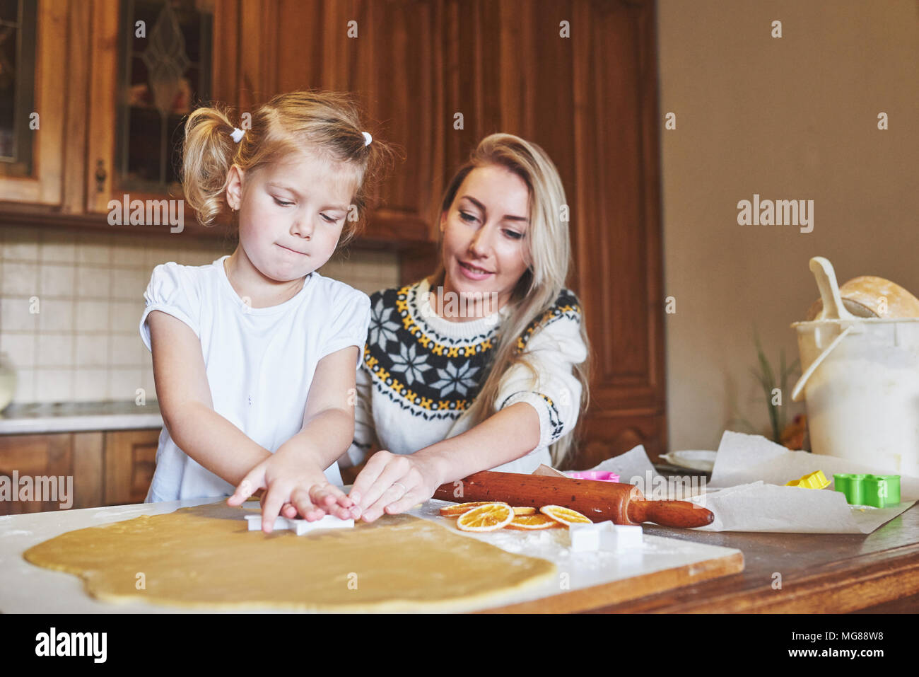 Happy girl with her mom dough Stock Photo Alamy