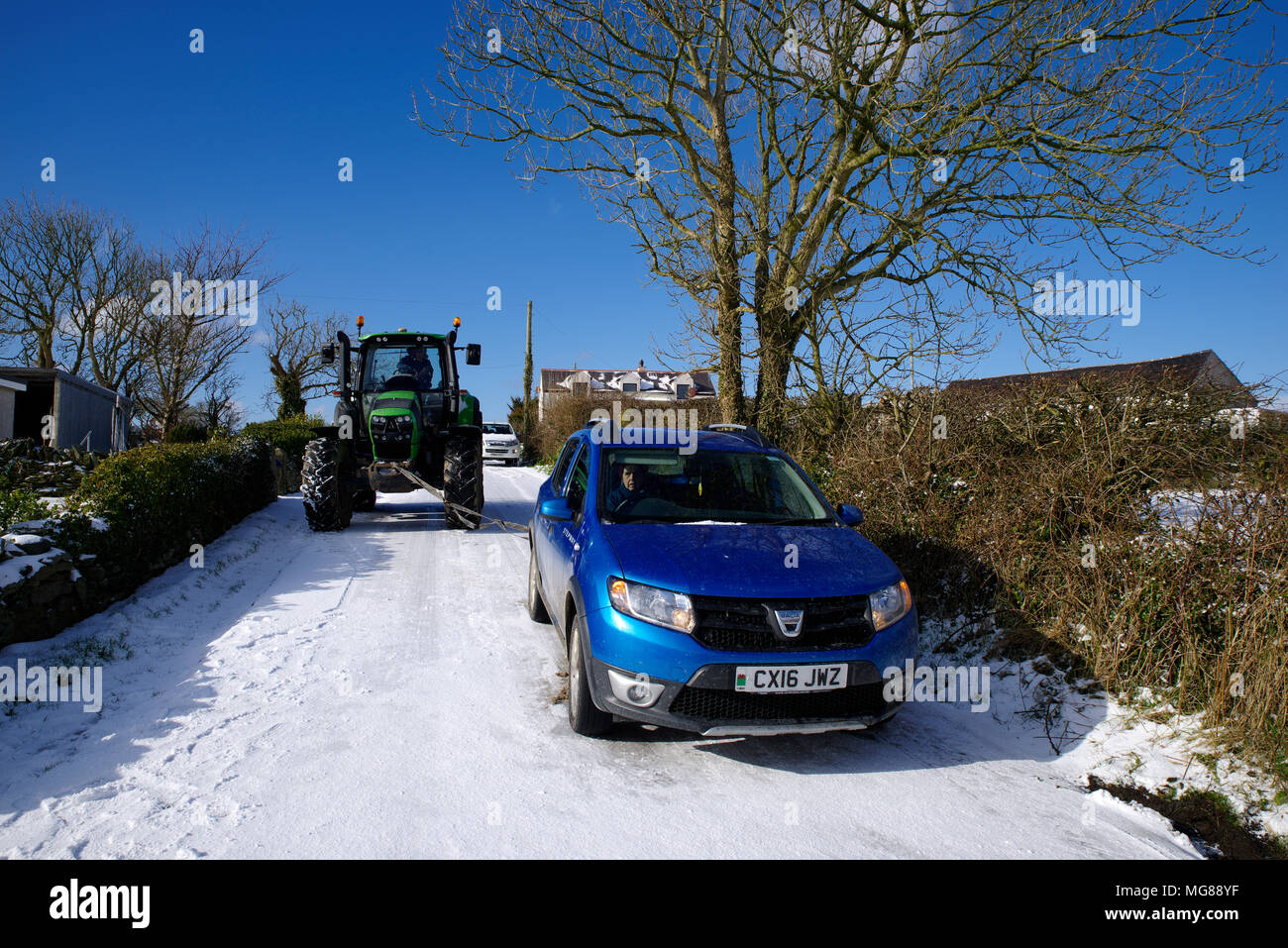 Vehicle on icy road Towed by tractor. Stock Photo