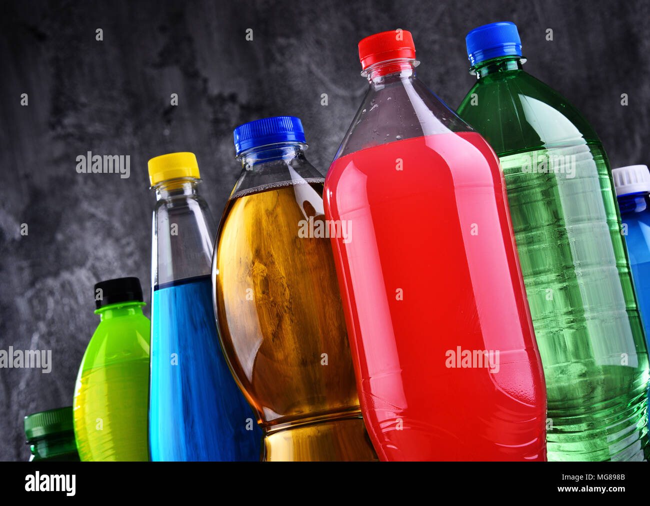 Plastic bottles of assorted carbonated soft drinks in variety of colors Stock Photo