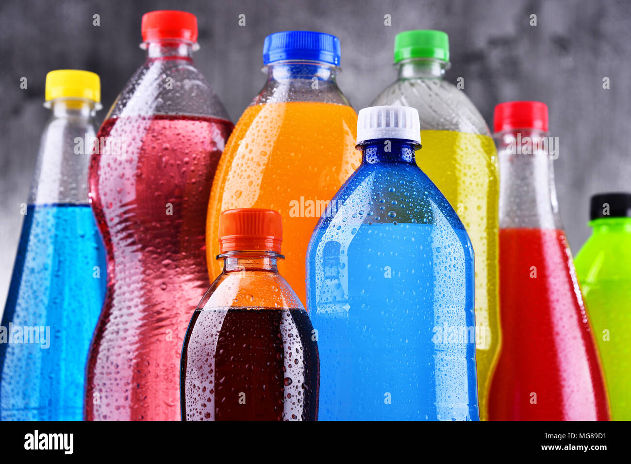 Plastic bottles of assorted carbonated soft drinks in variety of colors
