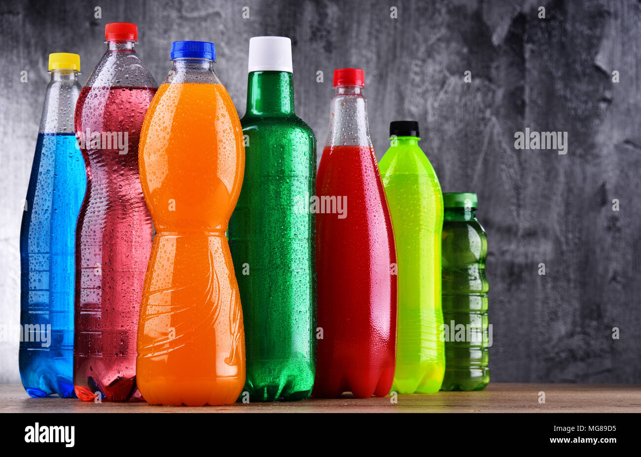 Plastic bottles of assorted carbonated soft drinks in variety of colors Stock Photo