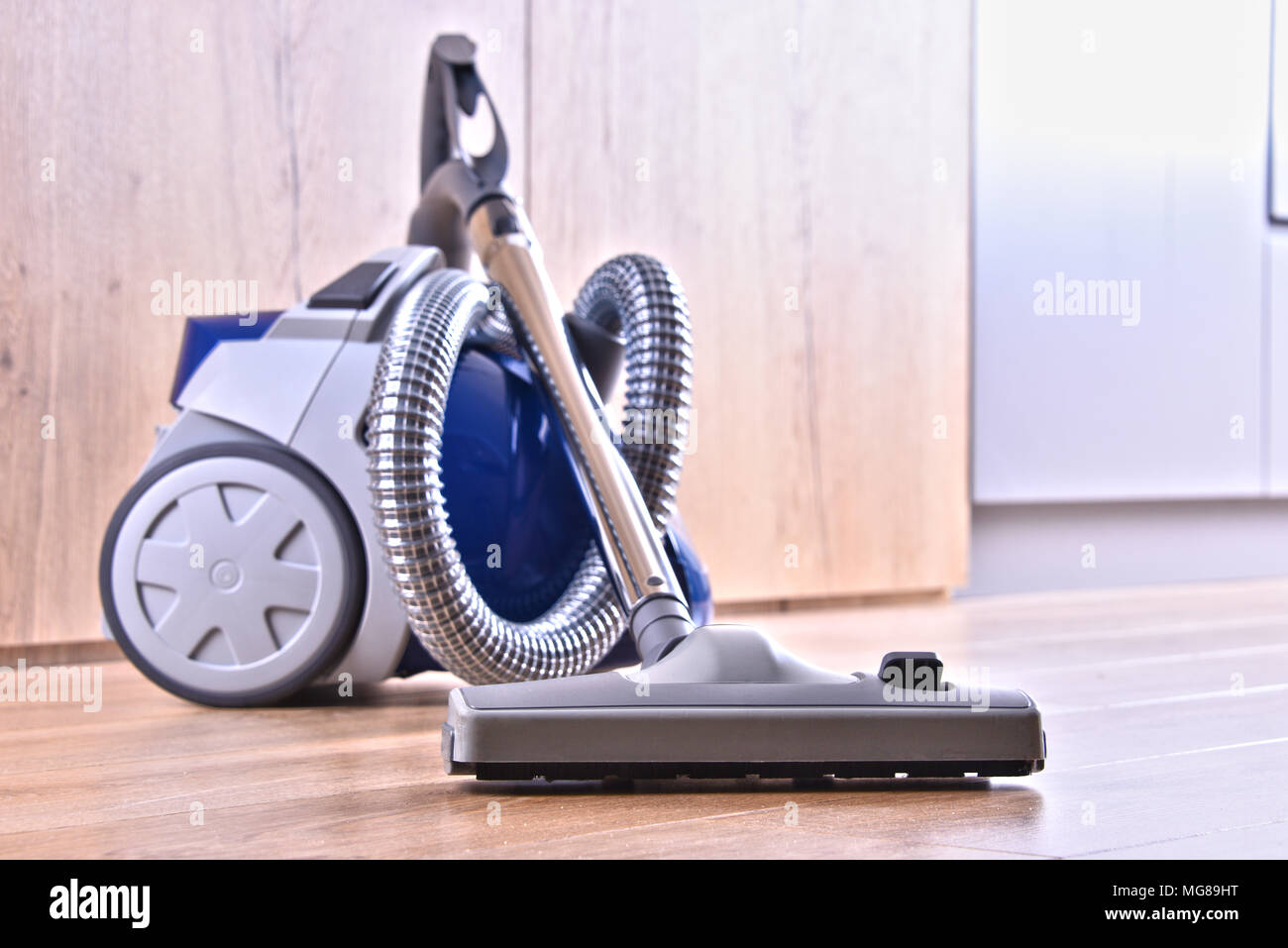 Canister vacuum cleaner for home use on the floor panels in the apartment Stock Photo Alamy