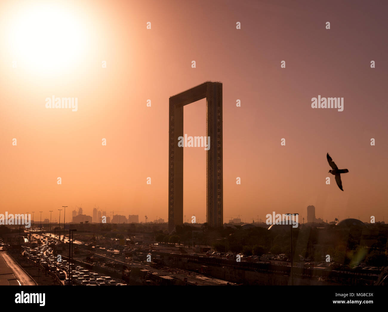 A beautiful Skyline and busy highway view of Dubai, UAE as seen from Dubai Frame at sunset Stock Photo