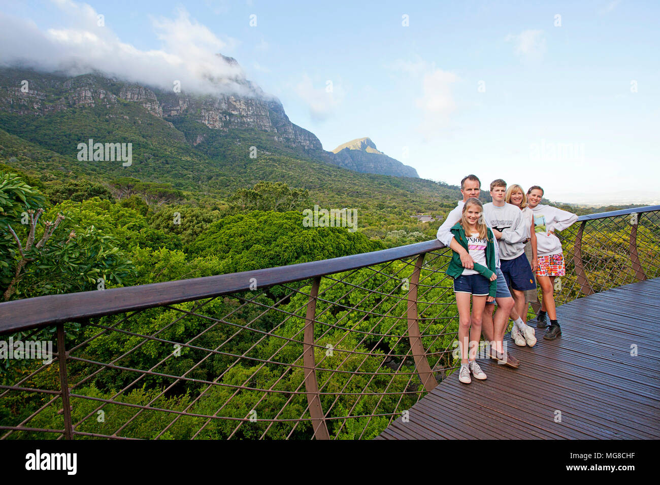 Family of five on the 'Boomslang' with tree canopy in background Stock Photo