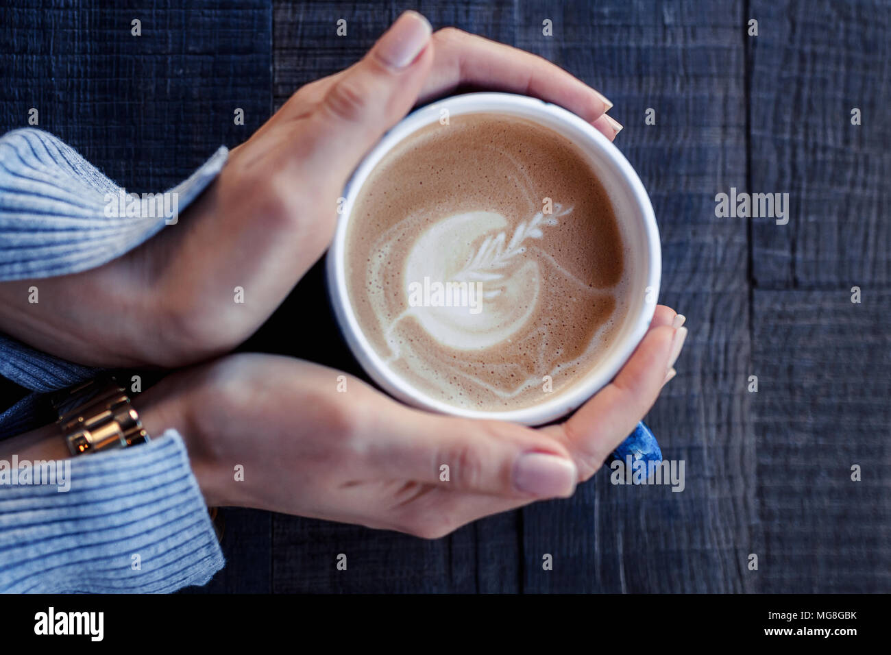 Artistic woman holding cup of coffee Stock Photo - Alamy