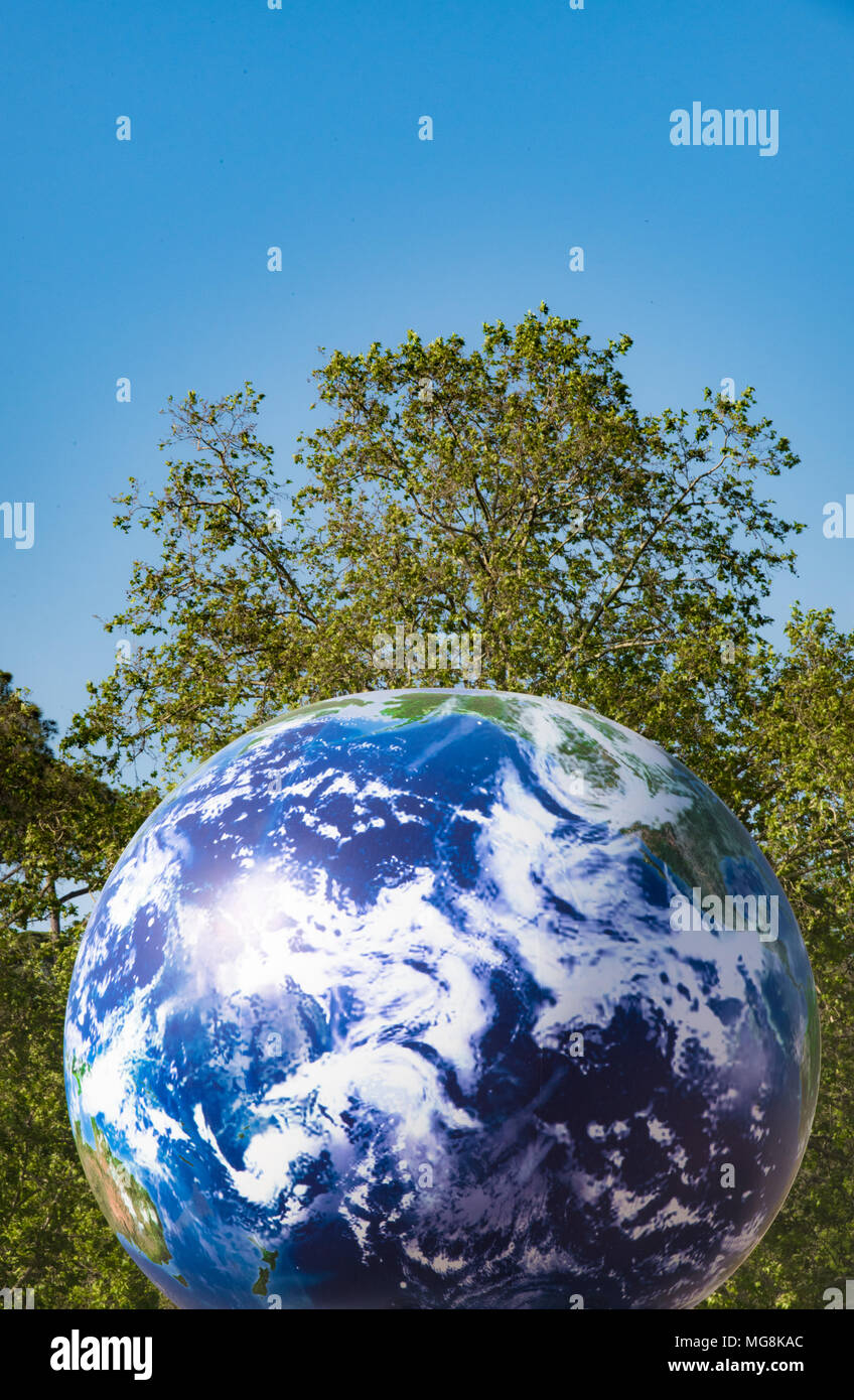 Big earth planet ball symbol over green tree park background Stock Photo