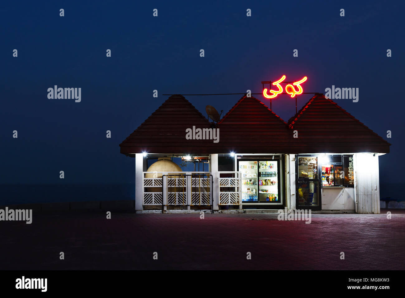 Shop at night along the Corniche in Kuwait City, Kuwait Stock Photo