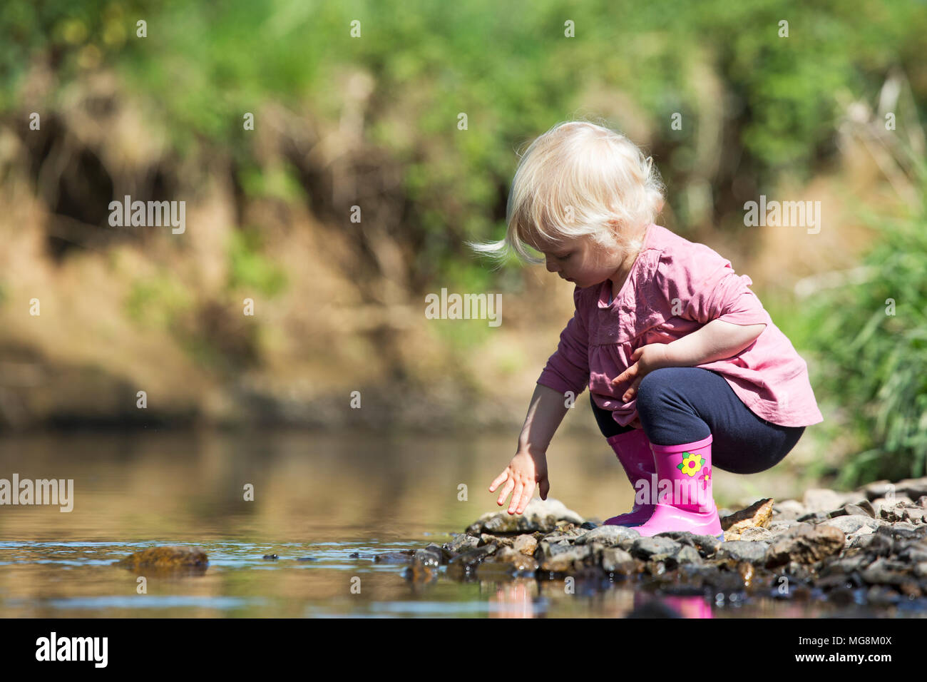 A small girrl playing in a river Stock Photo