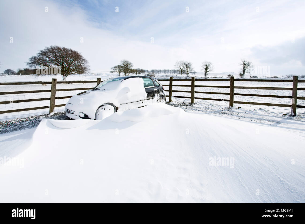 A car in Deep Snow drifts on Dartmoor,UK Stock Photo
