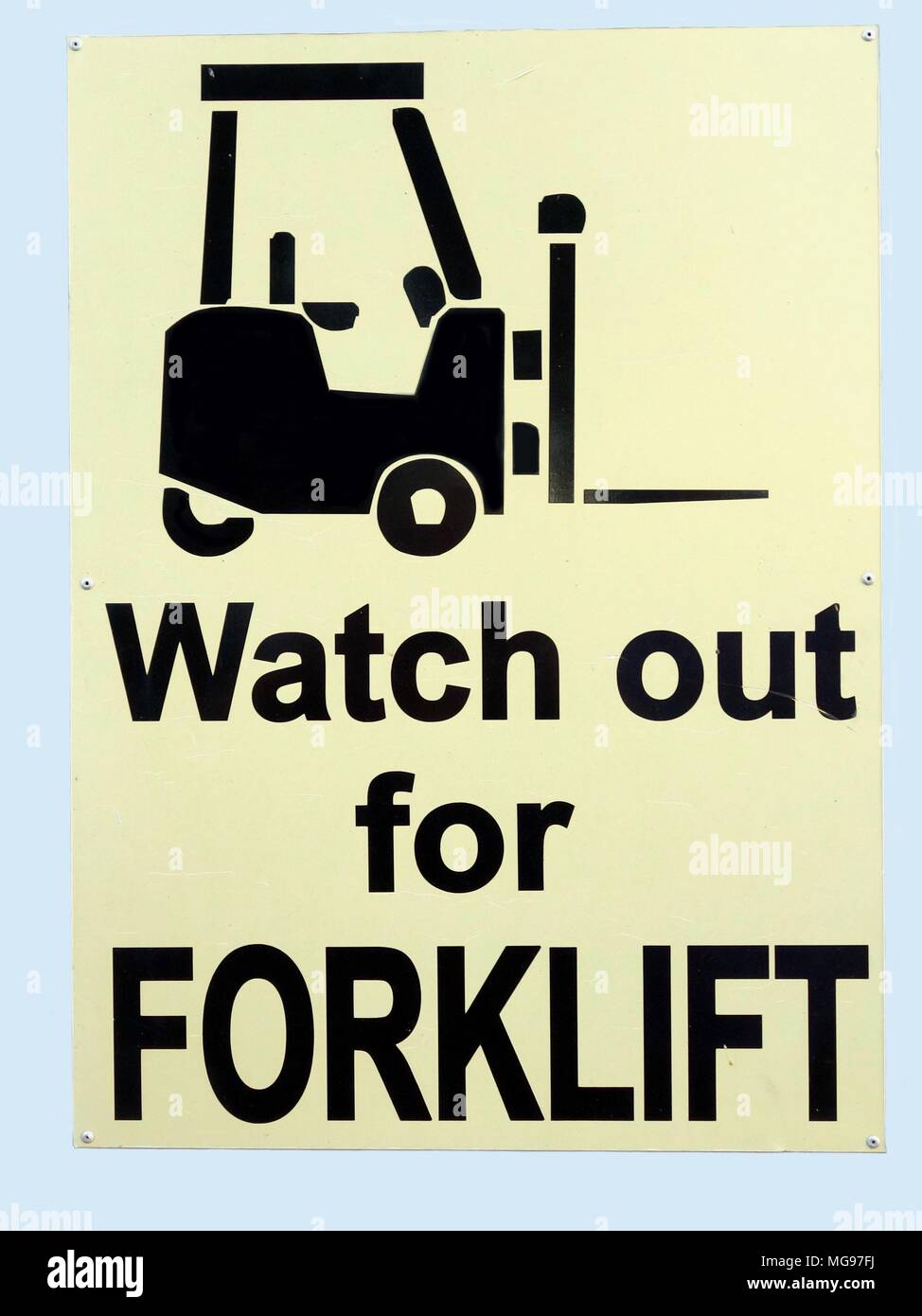 A warning sign informing people to care because forklift trucks are in operation in the area Stock Photo