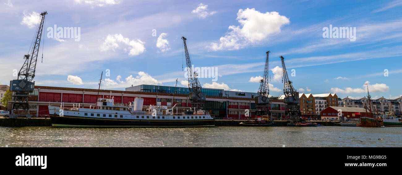 Panorama of Bristol's Floating Harbour. Boat and cranes in foreground, M-Shed in the background. Stock Photo