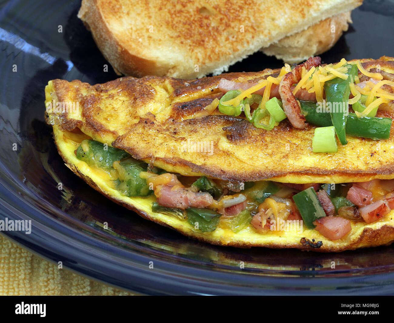 An extreme macro of a Western or Denver omelet.  Omelet includes ham, cheese, peppers, and onions. Stock Photo