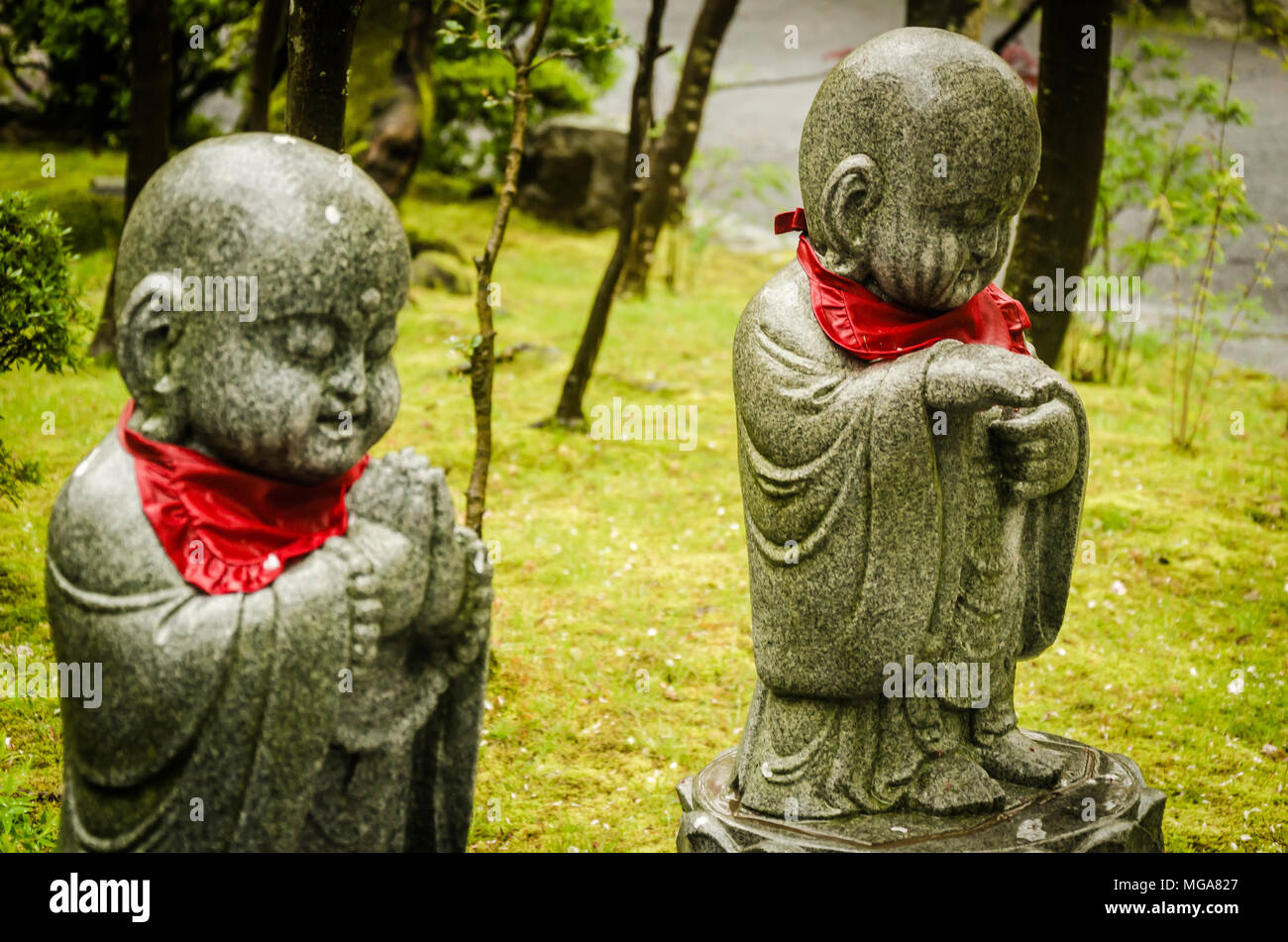 Stone statues of monks praying calmly in Japan Stock Photo Alamy