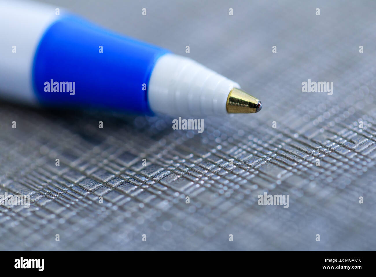 Closeup of a ballpoint pen, shallow depth of field with focus on top of