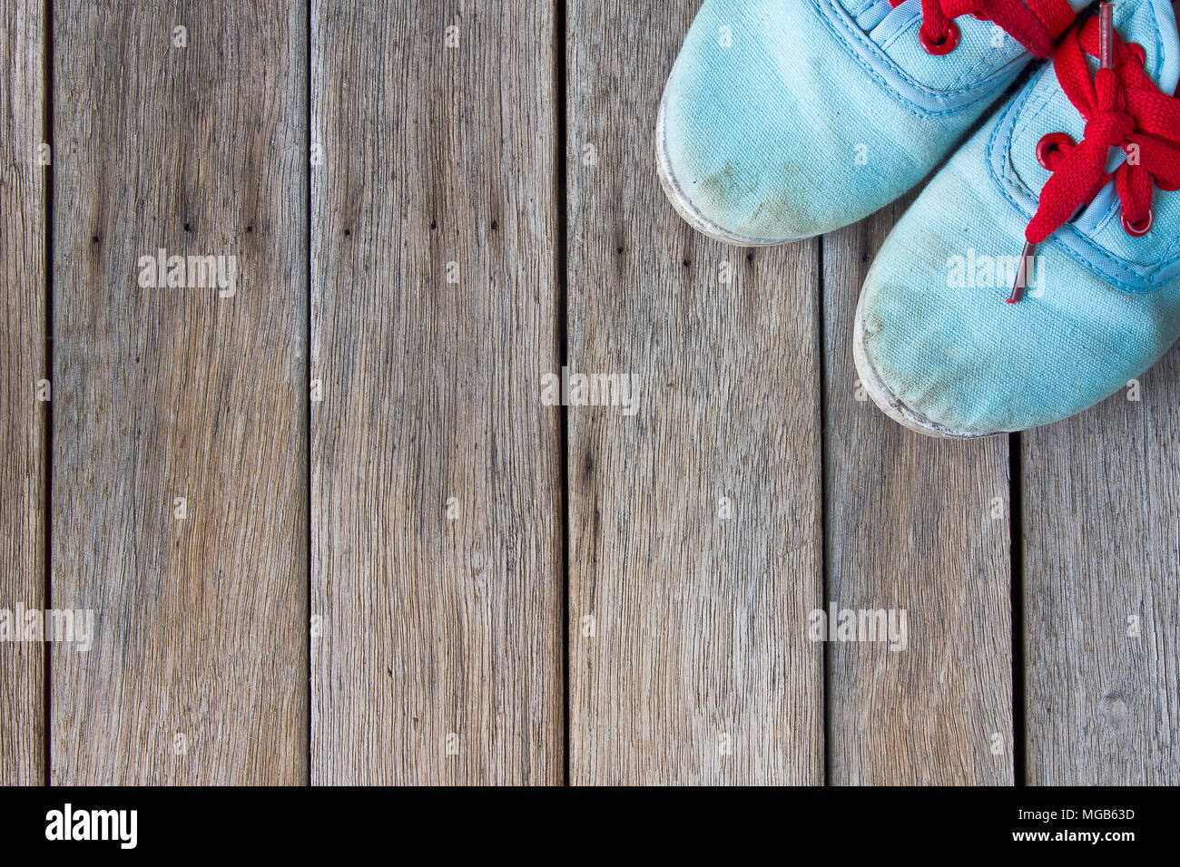 Old worn sneakers on a background of boards Stock Photo - Alamy