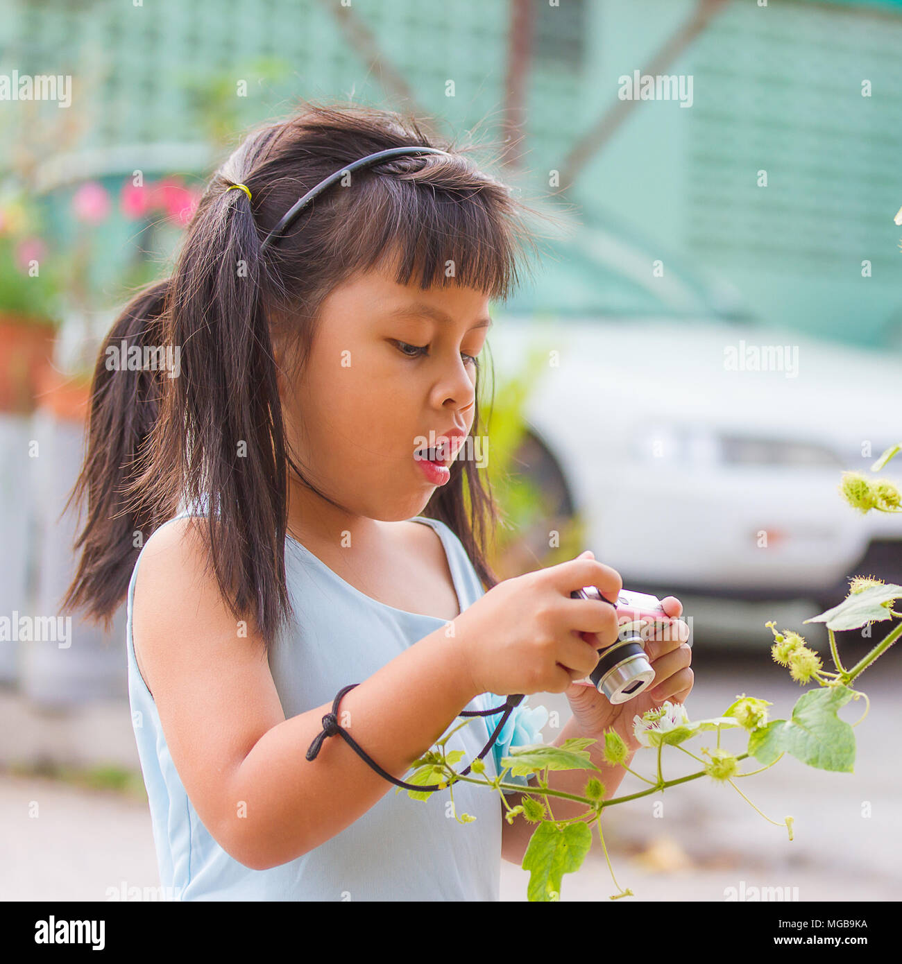 little asia girl taking photo and mouth open Stock Photo