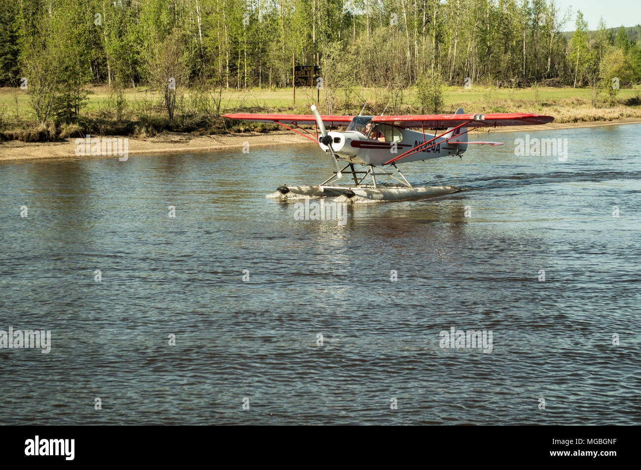 A water plane landing on a body of water in Fairbanks, Alaska Stock ...
