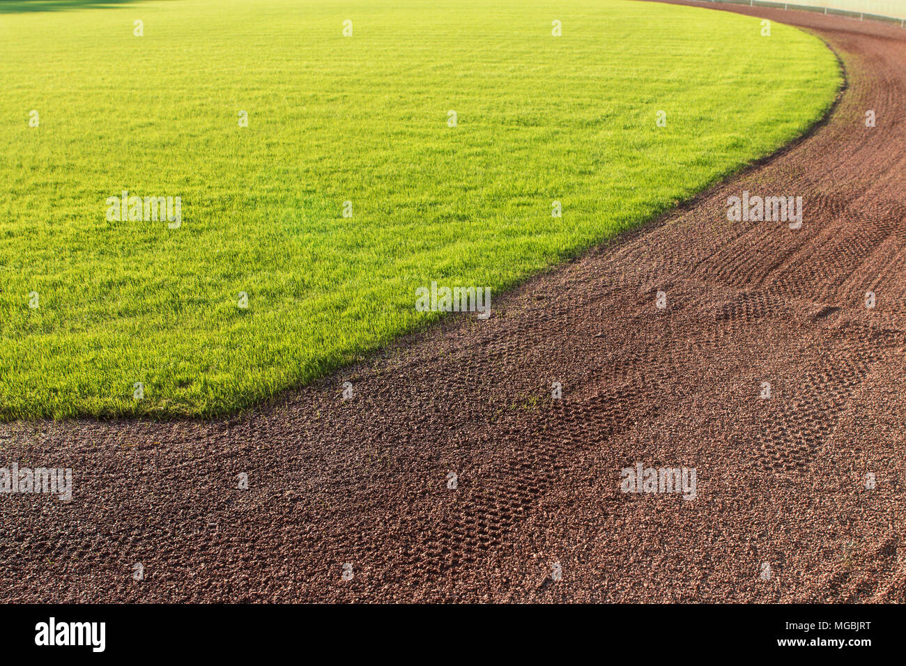 Outfield grass and warning track dirt of baseball field Stock Photo Alamy