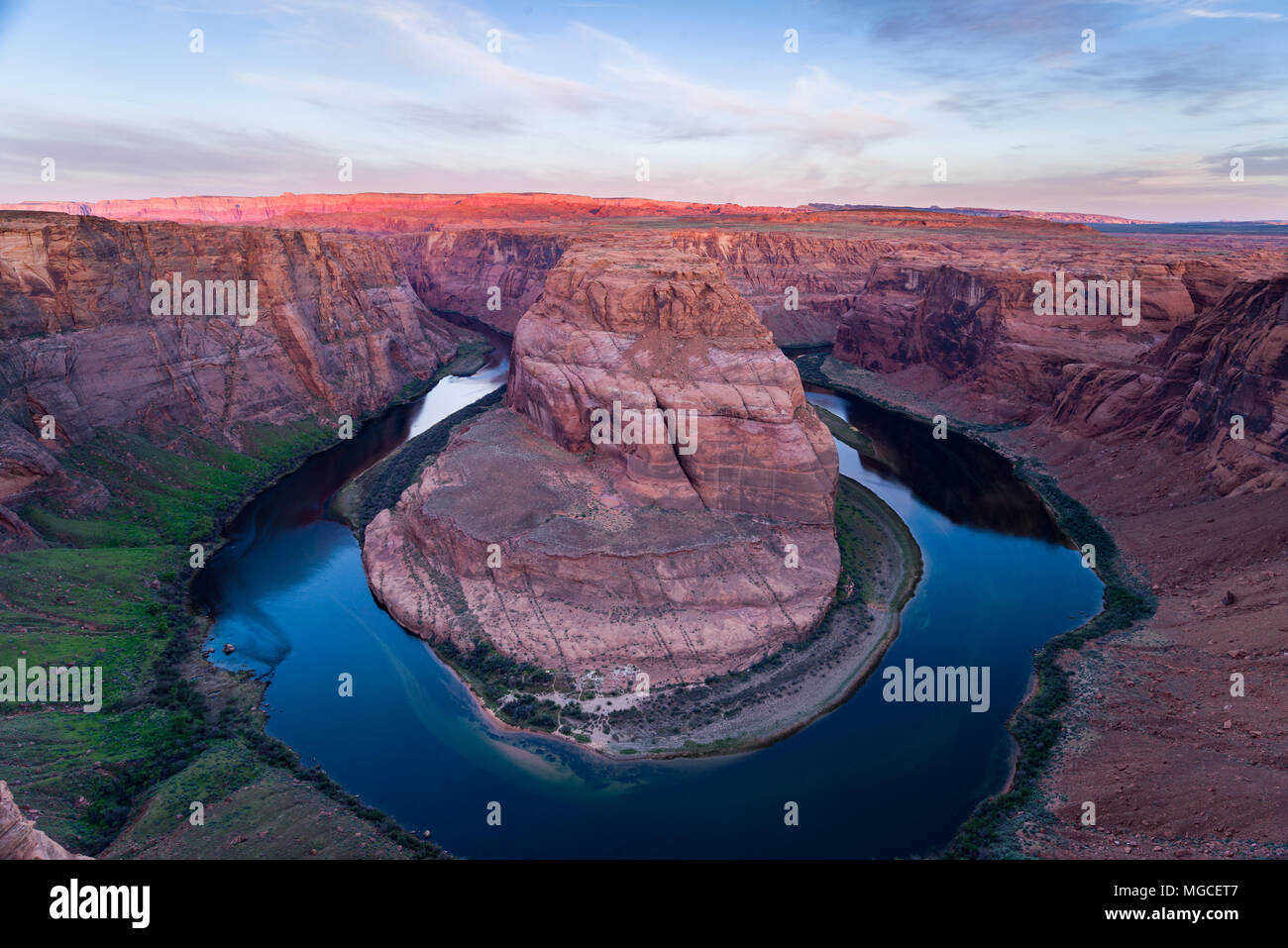 Horseshoe Bend at sunrise with the Colorado river flowing around through the canyon, Arizona Stock Photo