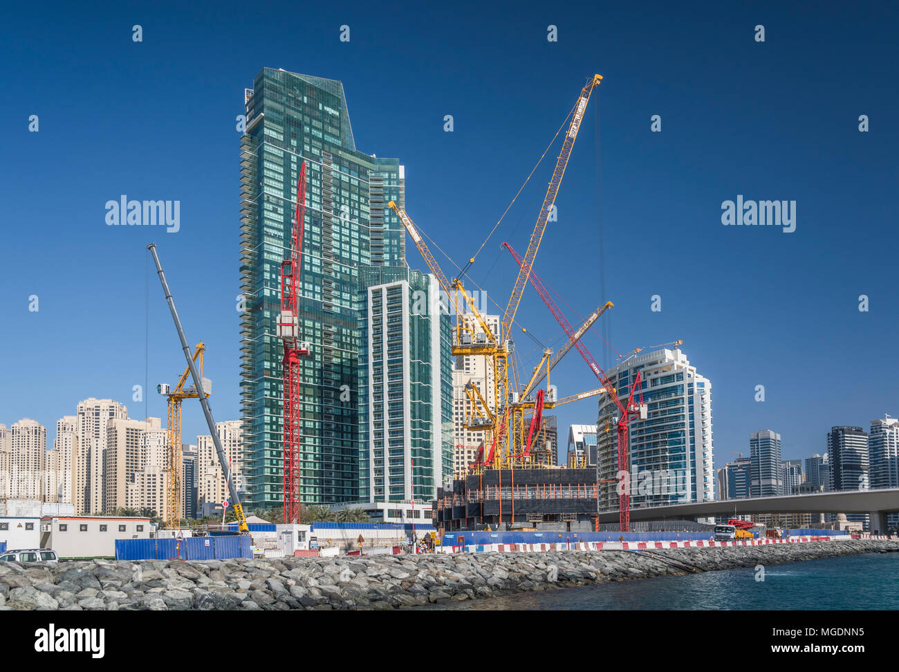 Building construction cranes in the marina of Dubai, UAE, Middle East. Stock Photo