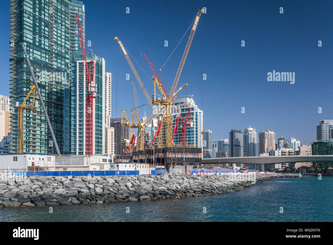 Building construction cranes in the marina of Dubai, UAE, Middle East. Stock Photo