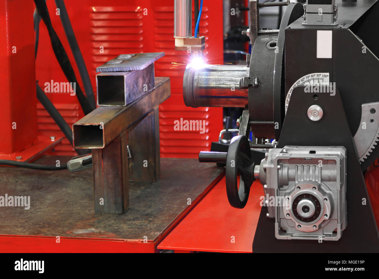 Automated robot welding gas pipe in workshop Stock Photo