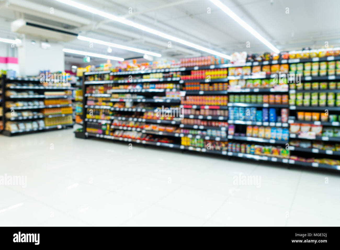 Supermarket goods shelf on blurred Stock Photo Alamy