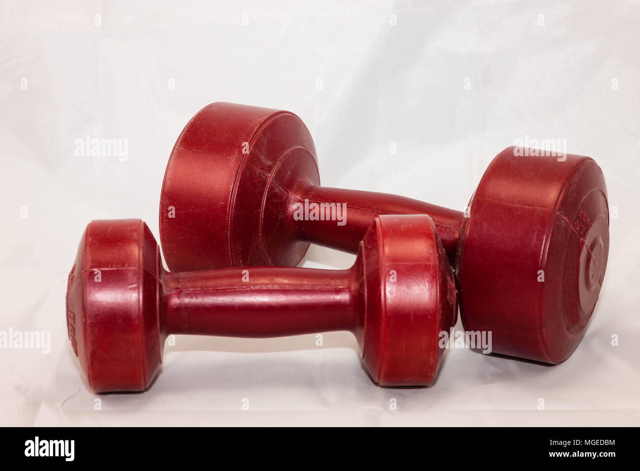 Red two and five pound hand weights for exercise Stock Photo Alamy