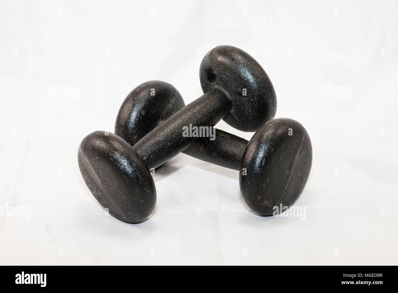 Two five pound black metal hand weights for exercise Stock Photo Alamy