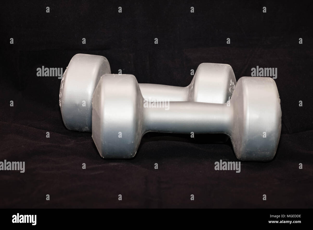 two silver five pound hand weights for exercise Stock Photo Alamy