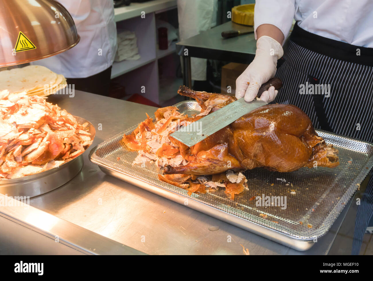 Chef slicing roasted Peking duck Stock Photo
