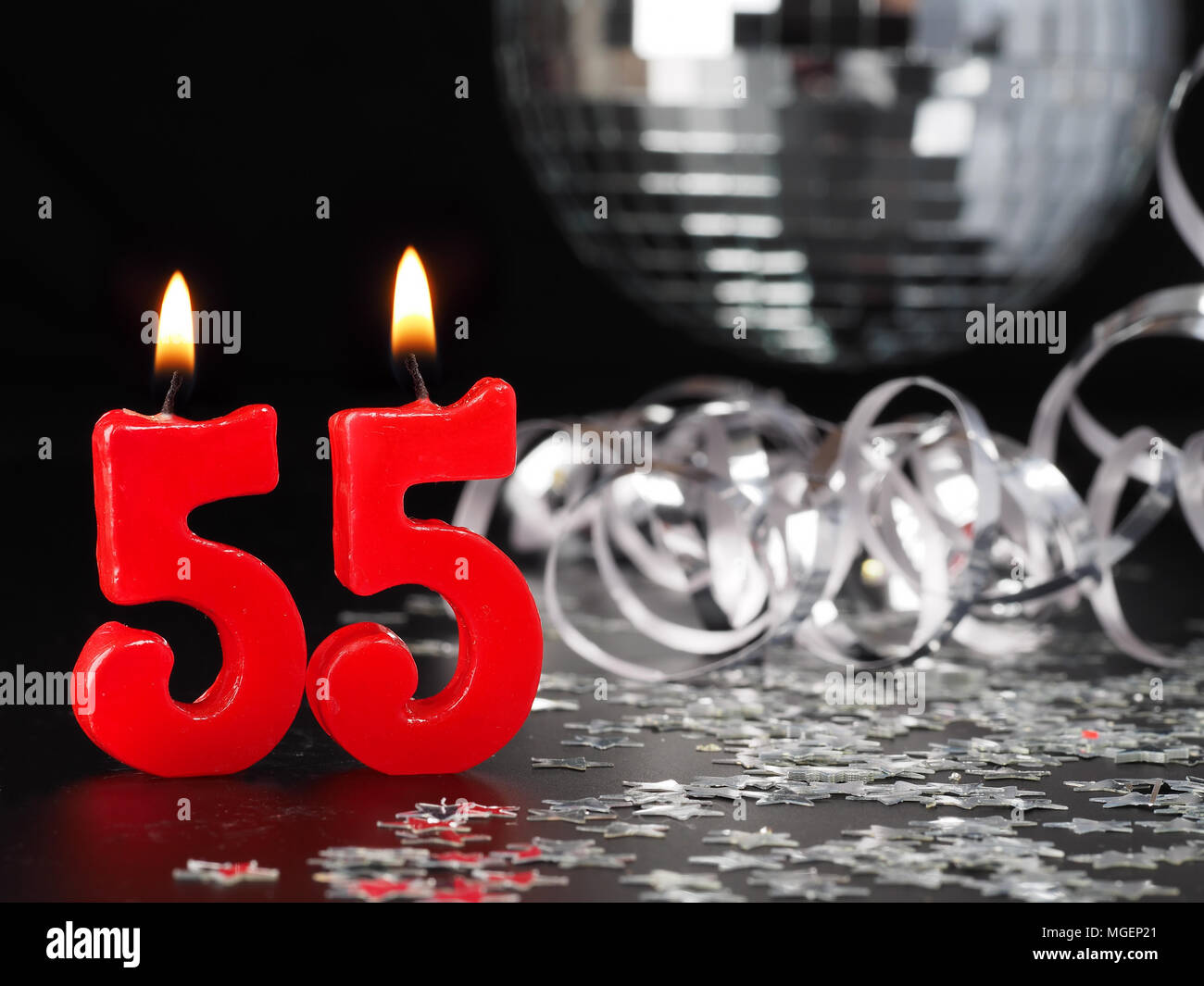 Red candles showing Nr. 55  Abstract Background for birthday or anniversary party. Stock Photo