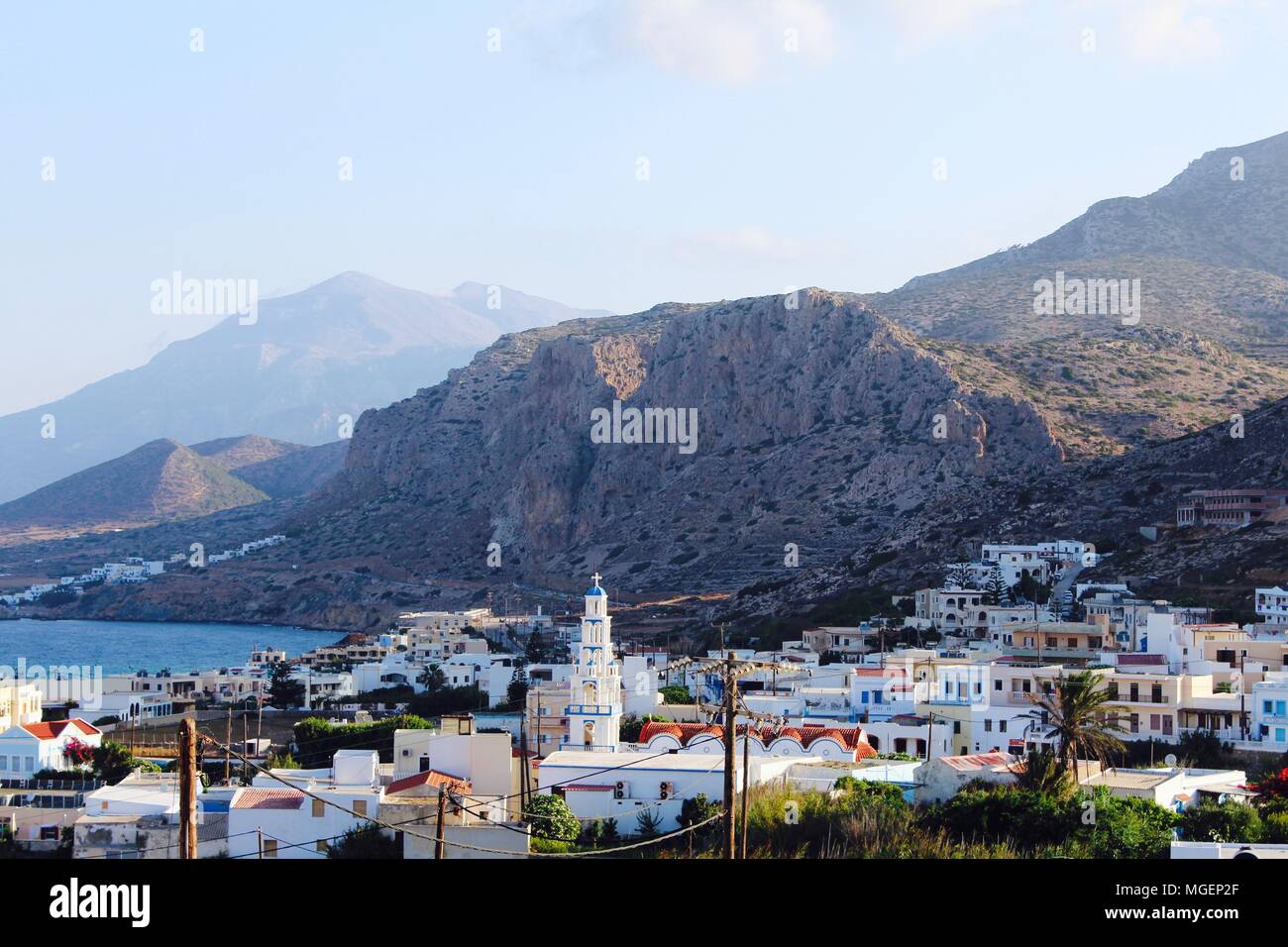 View of Arkasa village at dawn with the mountain headlands in the background on the island of Karpathos in Greece in the Mediterranean Sea Stock Photo
