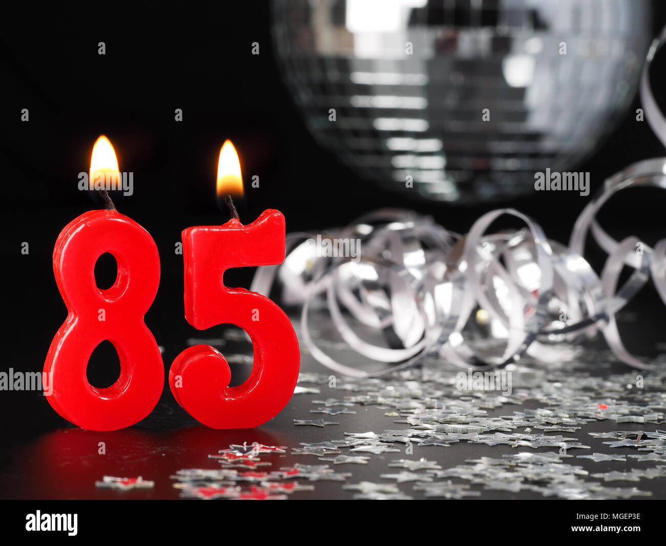 Red candles showing Nr. 85  Abstract Background for birthday or anniversary party. Stock Photo