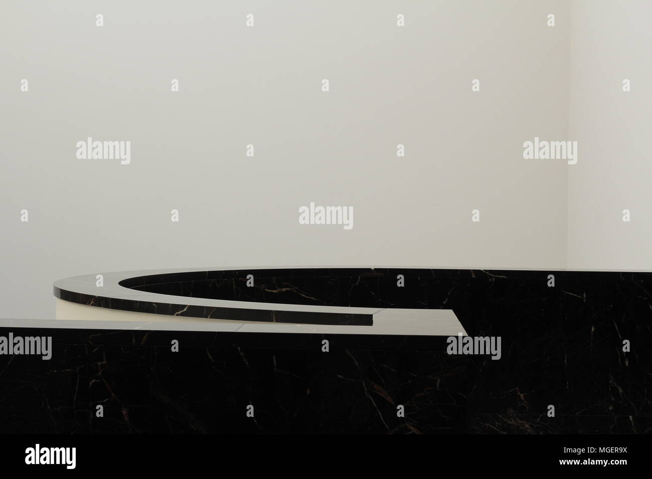 Geometry of architectural tools in black and white, black handrail that creates a strong contrast with the white wall in the background Stock Photo