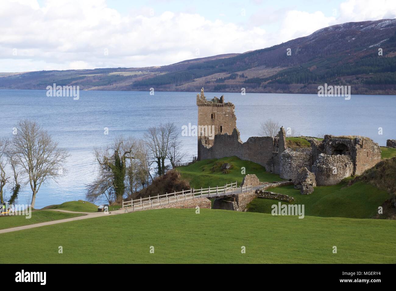 The ruins of the castle of Urquhart in Scotland on the shores of Lake Lochness, the castle stood in the middle of the green remained only more a tower Stock Photo
