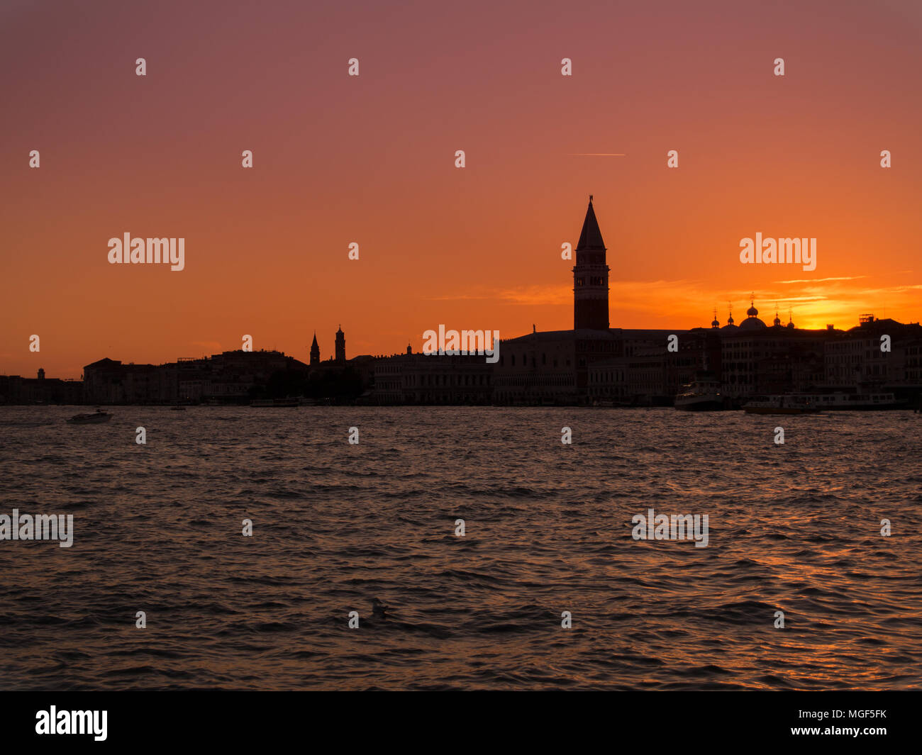 Orange sunset above the city of canals - Venice in Italy, the view on the Campanile of Saint Mark Stock Photo