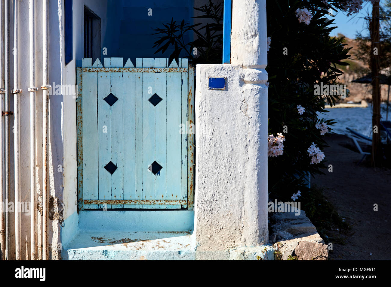 A blue wooden yard door of a white Aegean house Stock Photo - Alamy