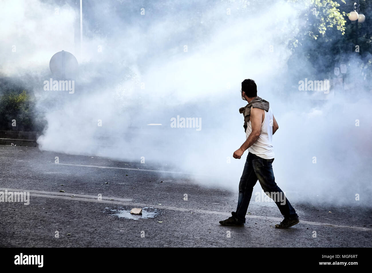 a male protester walking on the street in the midst of tear gas during the Gezi park events in 2013 in Ankara Turkey Stock Photo