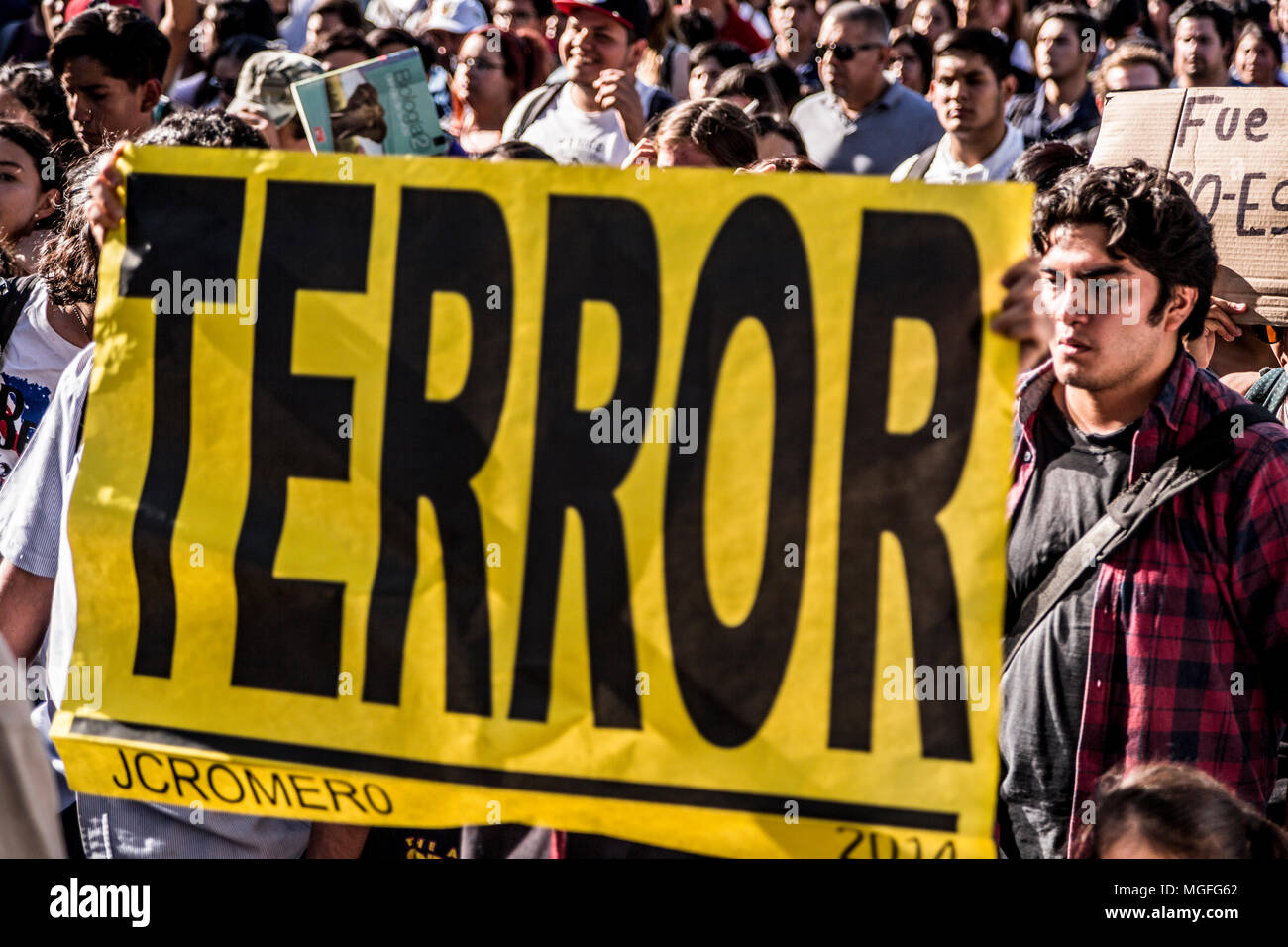 26 April 2018, Mexico, Guadalajara: Demonstrators carry a banner which reads 'Terror' during a protest march following the murder of three film students. Mexico is currently experiencing an unprecedented surge in violence, marking 2017 the bloodiest year in the country's recent history with more than 29,000 homicides and around 30,000 people presumed missing. Photo: Toni Rodriguez/dpa Stock Photo