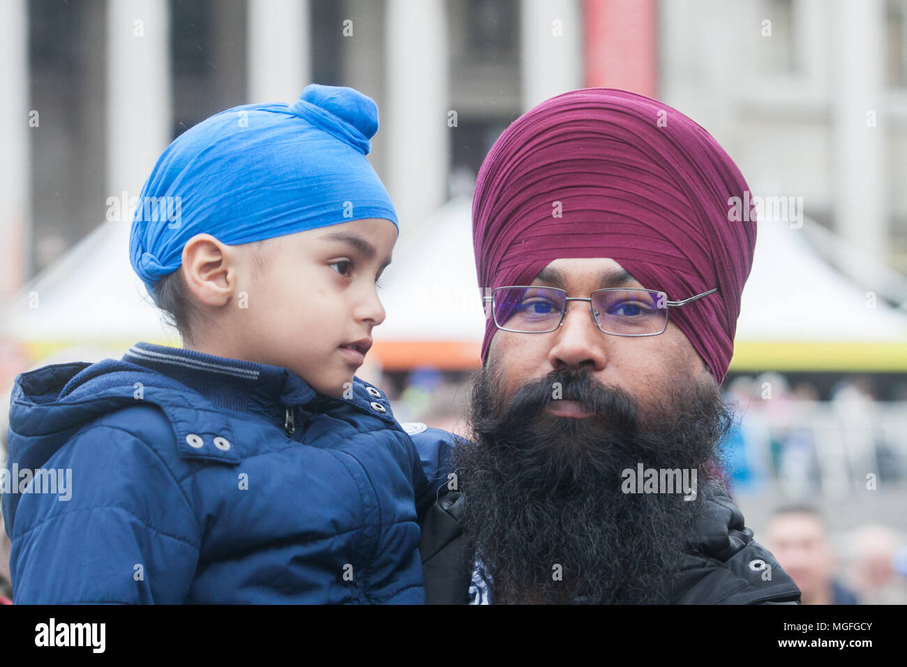 London UK. 28th April 2018. A father and son attend the Vaisakhi festival at Trafalgar Square hosted by Mayor of London which celebrates Sikh and Punjabi culture and traditions Credit: amer ghazzal/Alamy Live News Stock Photo