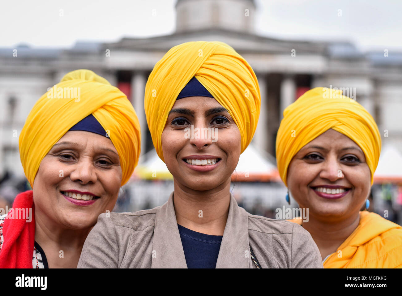 London, UK. 28 April 2018. (L to R) Sue Khanna, Kanika Sachdeva and Kamaljeet Sandhu pose wearing turbans during the festival of Vaisakhi in Trafalgar Square, hosted by the Mayor of London. For Sikhs and Punjabis, the festival celebrates the spring harvest and commemorates the founding of the Khalsa community over 300 years ago. Credit: Stephen Chung / Alamy Live News Stock Photo