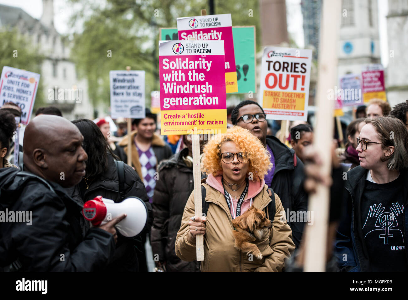 London, UK, 28 April 2018. A woman seen carrying a placard during the march. The Windrush generation solidarity protest gathered around 200 people at the Churchill Statue in Parliament Square to show disgust at the government's treatment of those from the Windrush generation. 'Despite the government's recent actions to attempt to rectify it, this never should have happened in the first place', they say. Credit: SOPA Images Limited/Alamy Live News Stock Photo