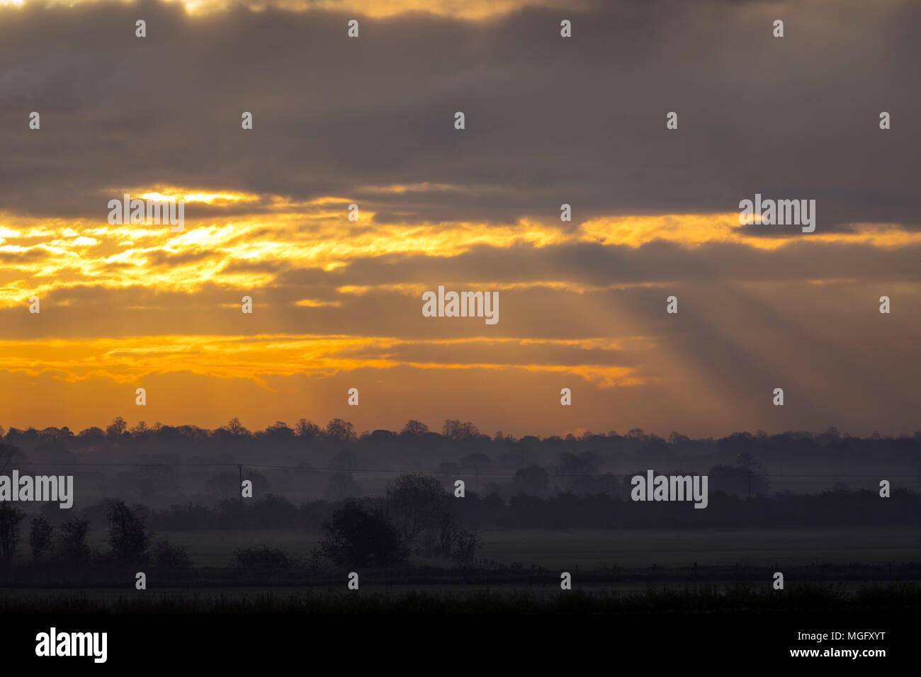 A cold and misty start to the day at sunrise over the Cheshire plain towards Chester, Cheshire Stock Photo