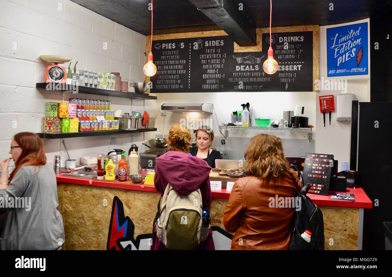 the vegan pie shop interior camden market london UK with customers and